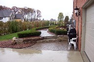 Boulder Retaining Wall, Interlocking Paver Patio, Drainage System
